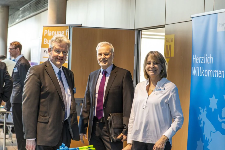 Herr Brämer (TMDI), Frau Malcherek (TMDI) und eine weitere Person Posen für ein Bild